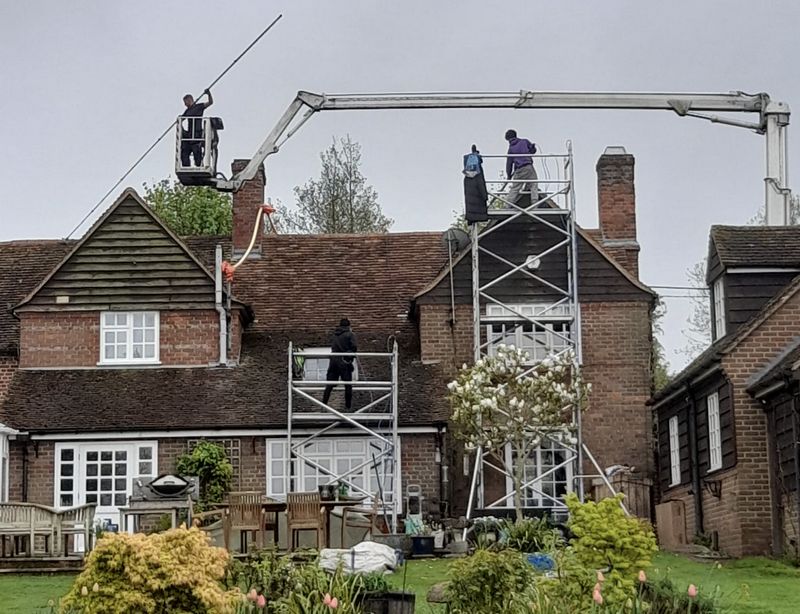 The Moss Cleaners using cherry picker and scaffolding to clean roof safely and professionally in Greenford, {{COUNTY}}
